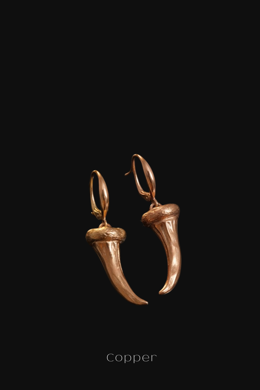 A pair of gold-colored earrings with a pointed design, displayed against a black background.