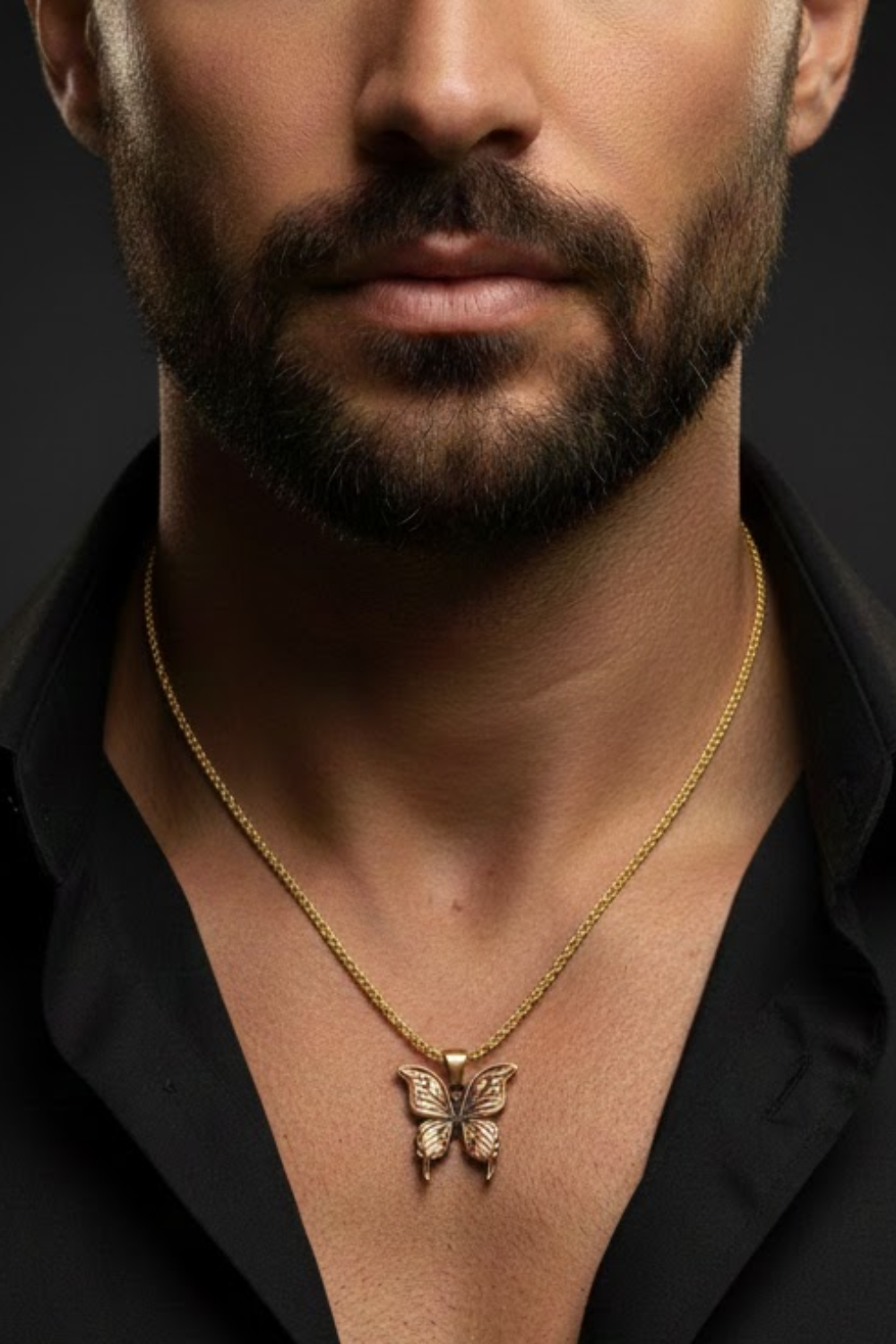 A close-up of a man's neck and chest area, with a gold butterfly pendant necklace visible.