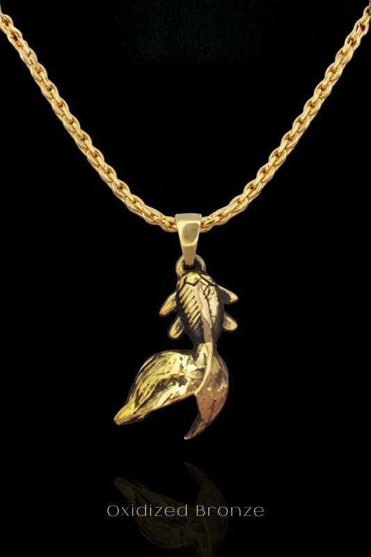 A gold-colored necklace with a pendant in the shape of a fish.