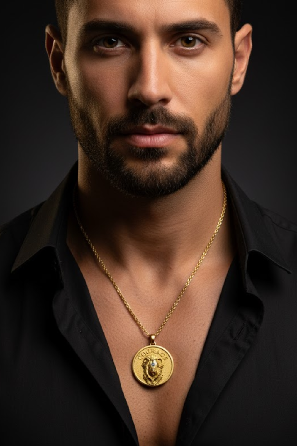 A man wearing a black shirt and a gold necklace with a large pendant is shown in a close-up portrait against a dark background.