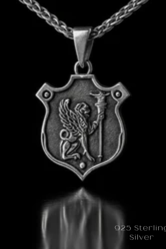 A silver-colored pendant necklace with a shield-shaped pendant featuring a winged lion or mythical creature.