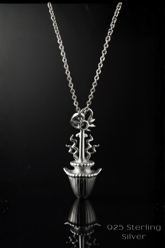 A silver necklace with a pendant featuring a stylized floral design.