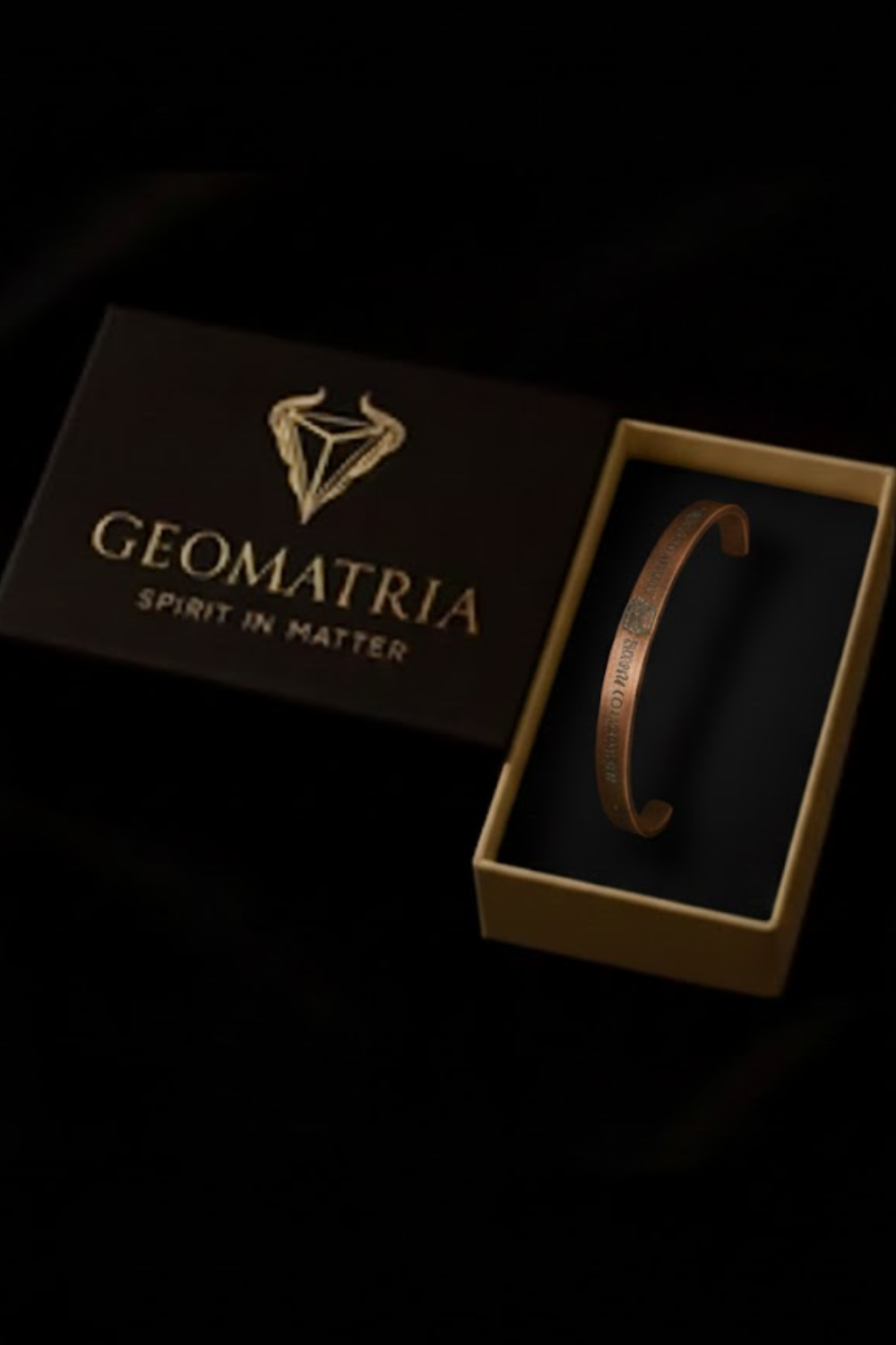 A bracelet is displayed in an open box with the text "Geomatria" and "SPIRIT IN MATTERS" printed on it.