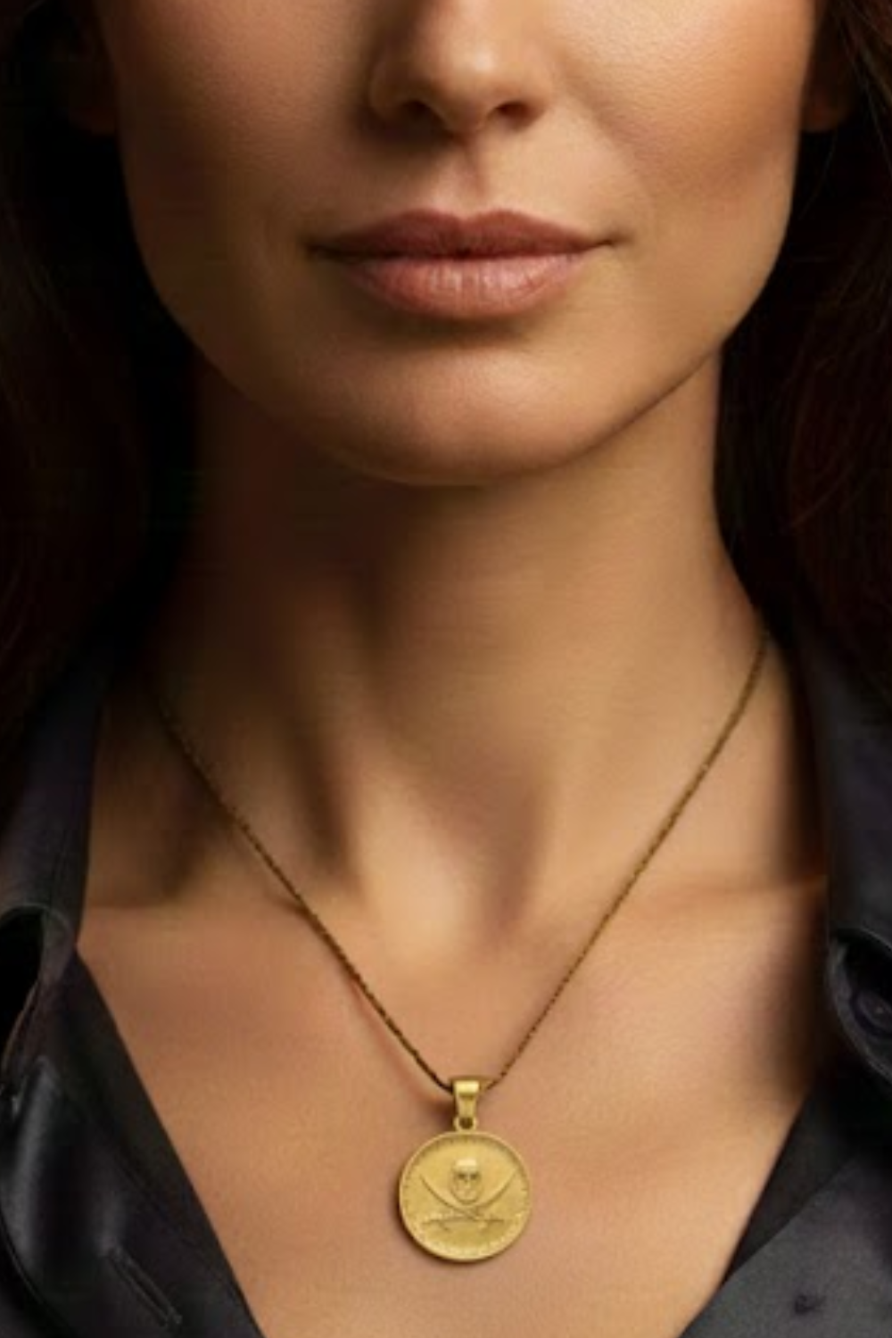 A close-up of a woman's neck and chest area, with a gold-colored pendant necklace featuring a skull and crossbones design.
