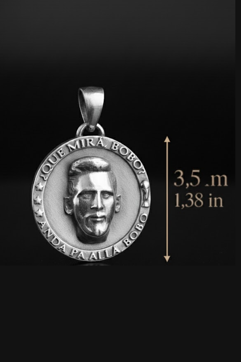 a silver pendant with a portrait of a person on it, and there is a measurement scale indicating the size of the pendant in inches.