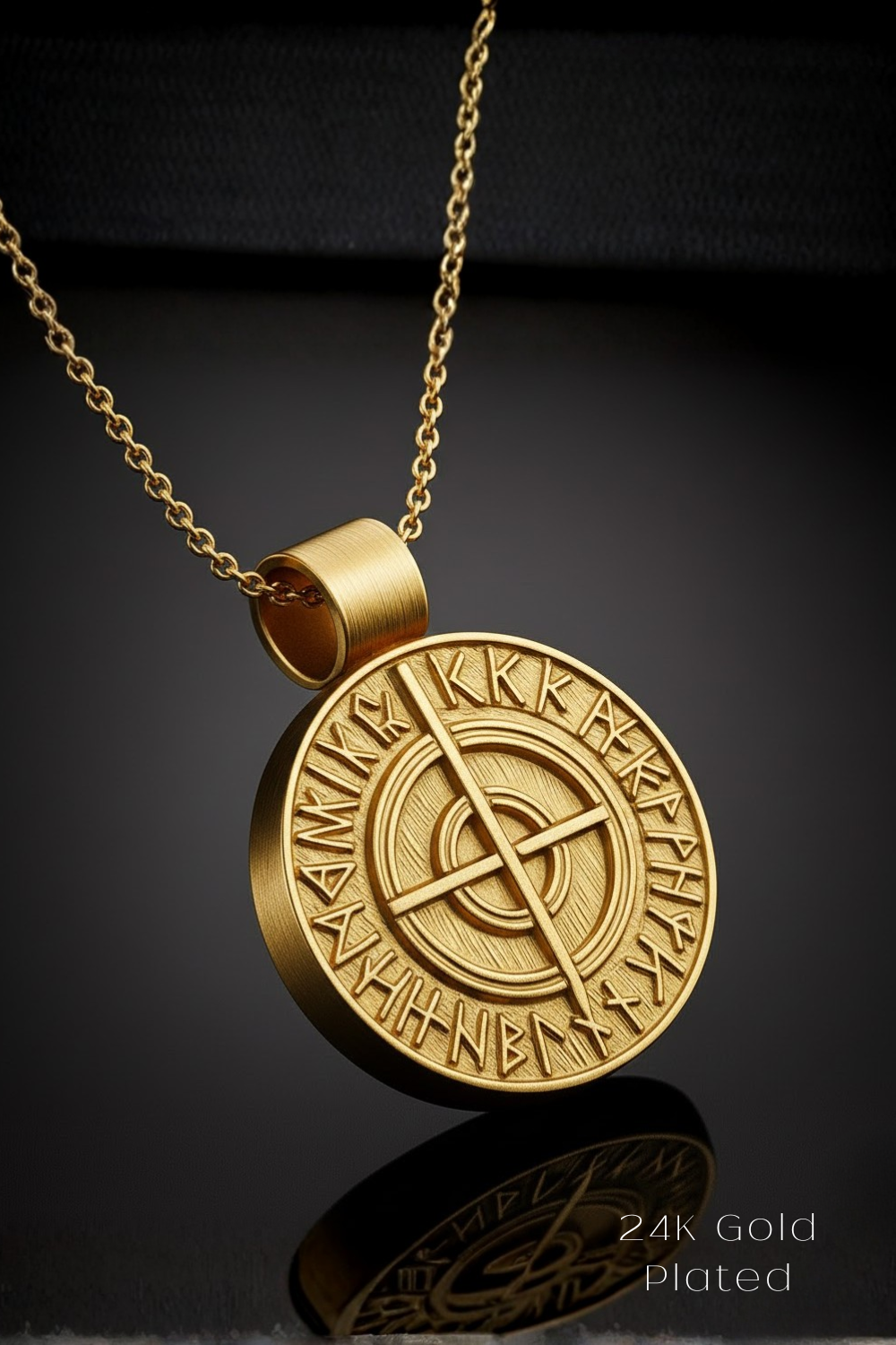 A gold-colored pendant necklace with a circular medallion featuring an intricate design and text.