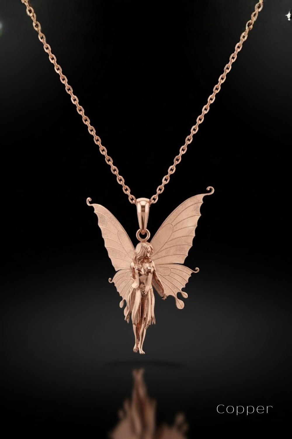 A delicate pendant in the shape of a fairy with butterfly wings, suspended from a chain against a dark background.