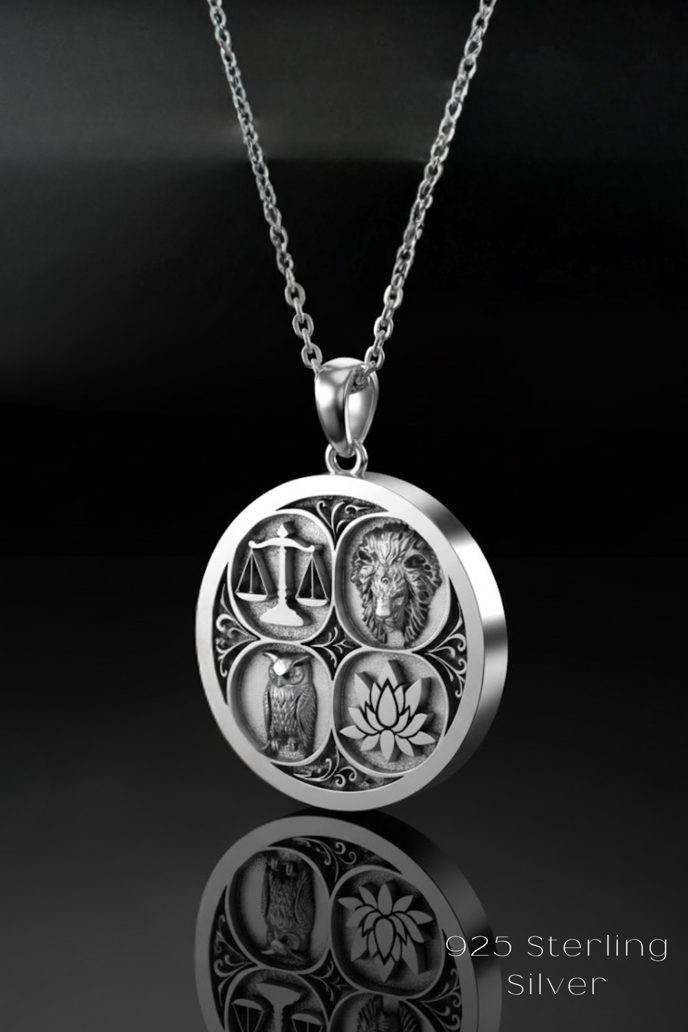 A silver pendant necklace with a circular design featuring four distinct symbols: an owl, a lion, a lotus flower, and a scale.