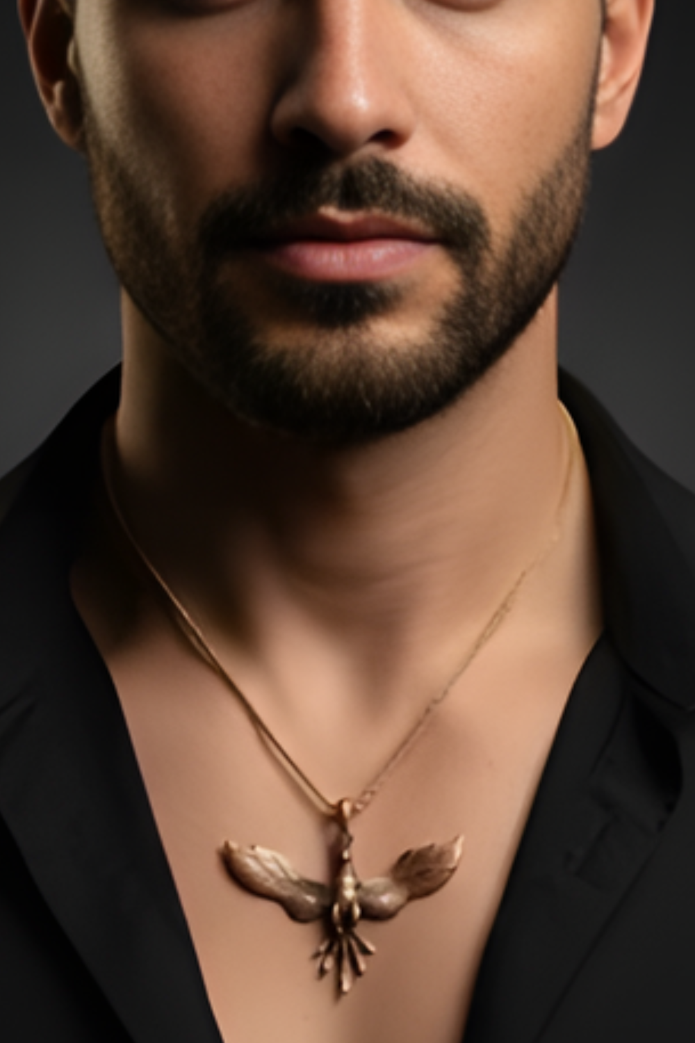 A close-up of a man's neck and chest area, with a gold-colored pendant necklace featuring a bird design.