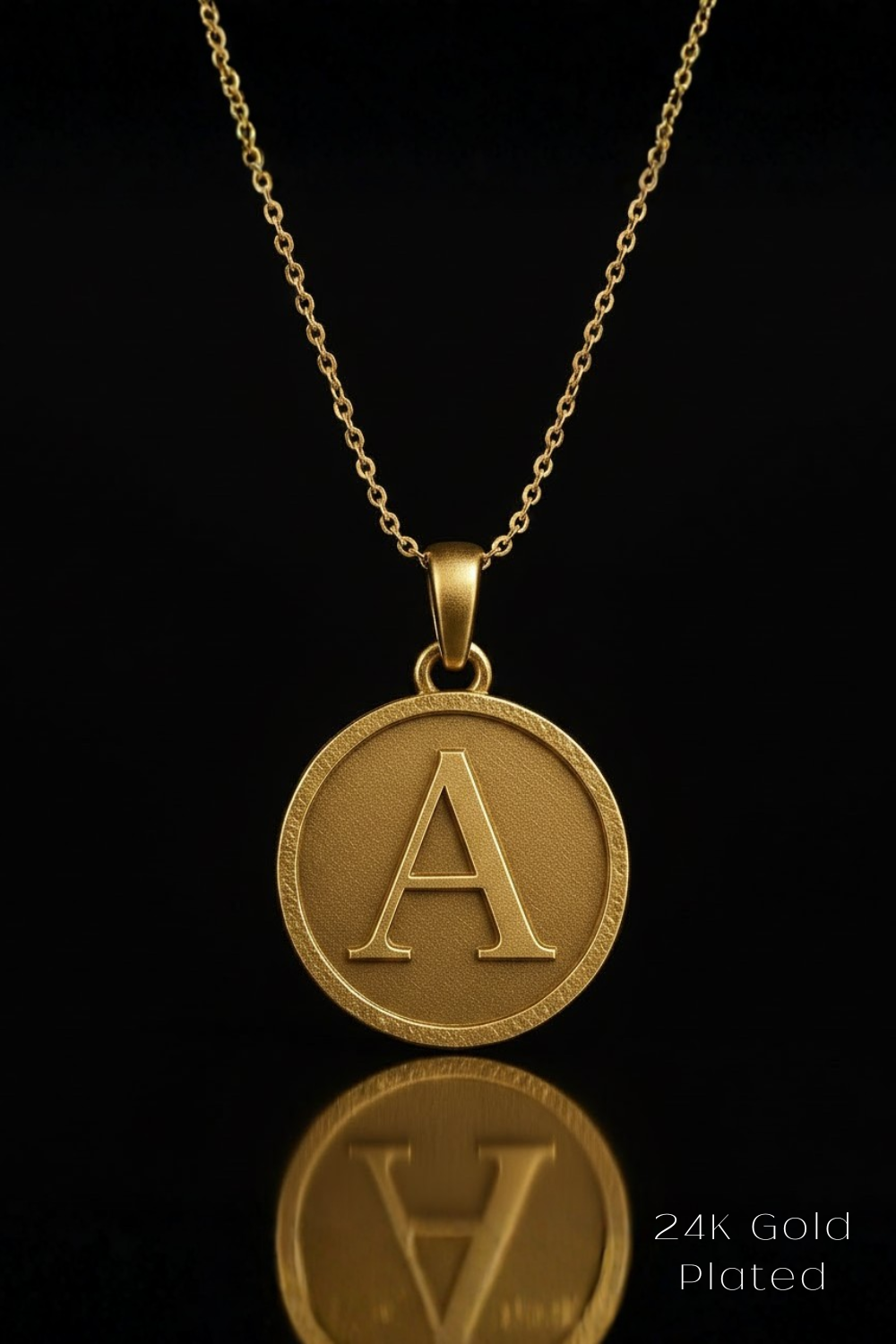 A gold-colored necklace with a large circular pendant featuring the letter "A" in the center.
