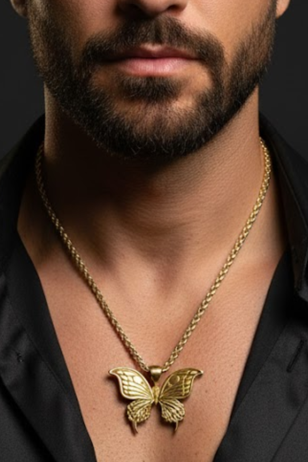 A close-up of a man's neck and chest area, with a gold butterfly pendant necklace prominently displayed.