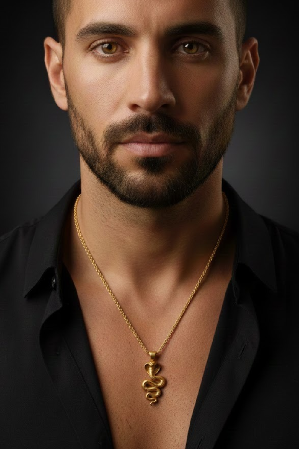 A man with a beard wearing a black shirt and a gold necklace with a pendant.