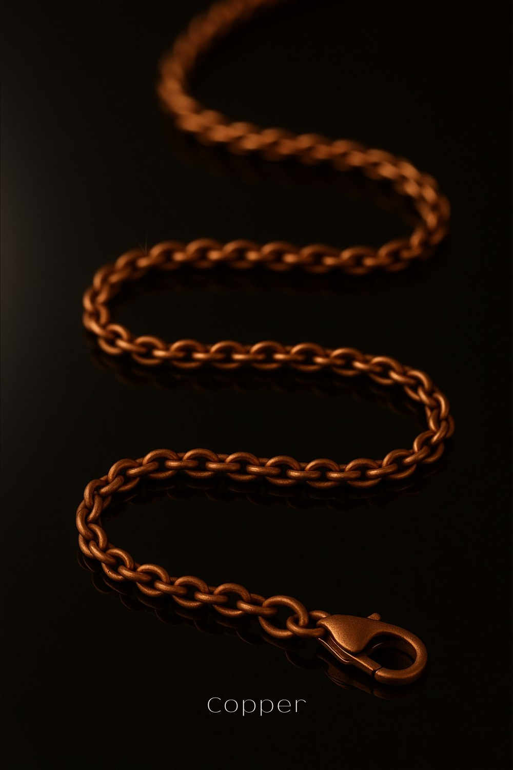 A copper-colored chain with a clasp is shown against a dark background.