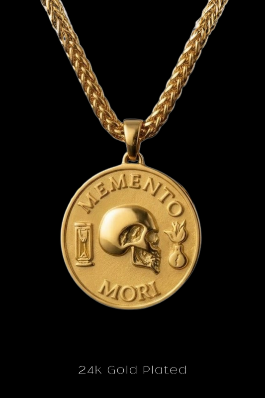 A 24k gold plated pendant necklace with a medallion featuring a skull and the Latin phrase "Memento mori" (which means "Remembering the dead" in English).