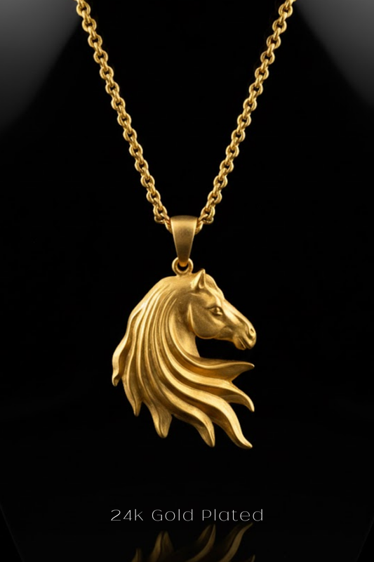 A 24k gold plated pendant in the shape of a horse's head is displayed against a black background.