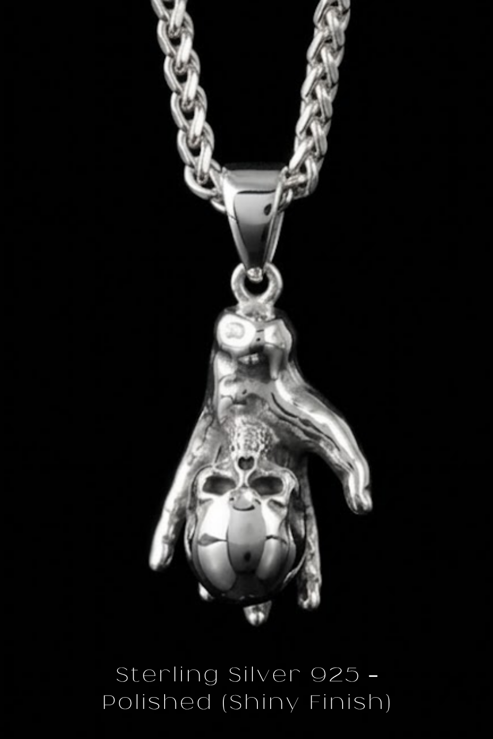 A silver-toned pendant necklace with a skull-shaped pendant hanging from a chain.