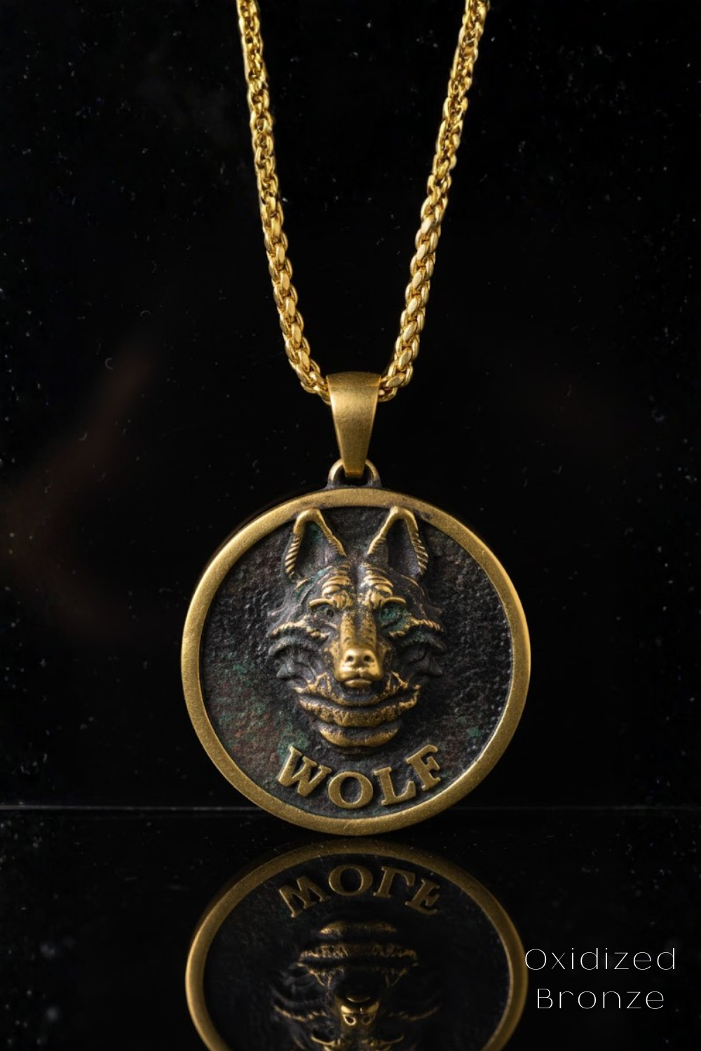 A gold-colored pendant necklace with a circular medallion featuring a detailed bronze wolf face design.