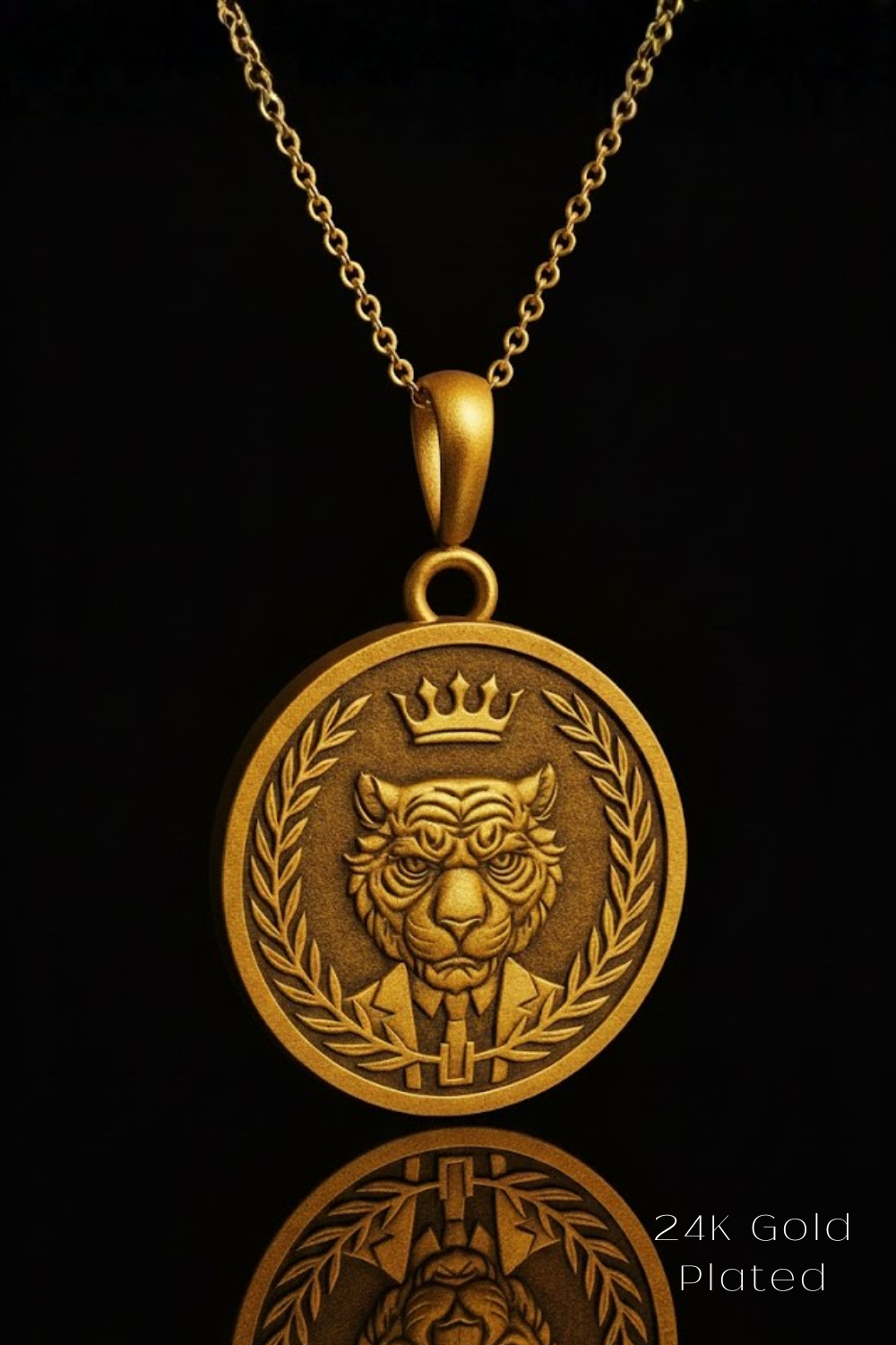 A gold-plated pendant featuring a detailed engraved image of a tiger wearing a crown, set against a dark background.