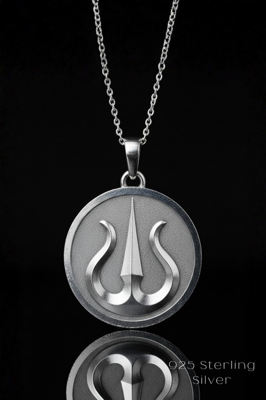 A silver necklace pendant with a circular design featuring a stylized symbol, such as a trident or a similar weapon, against a black background.