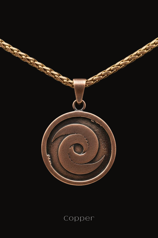 A copper-colored pendant with a spiral design, suspended from a chain against a black background.