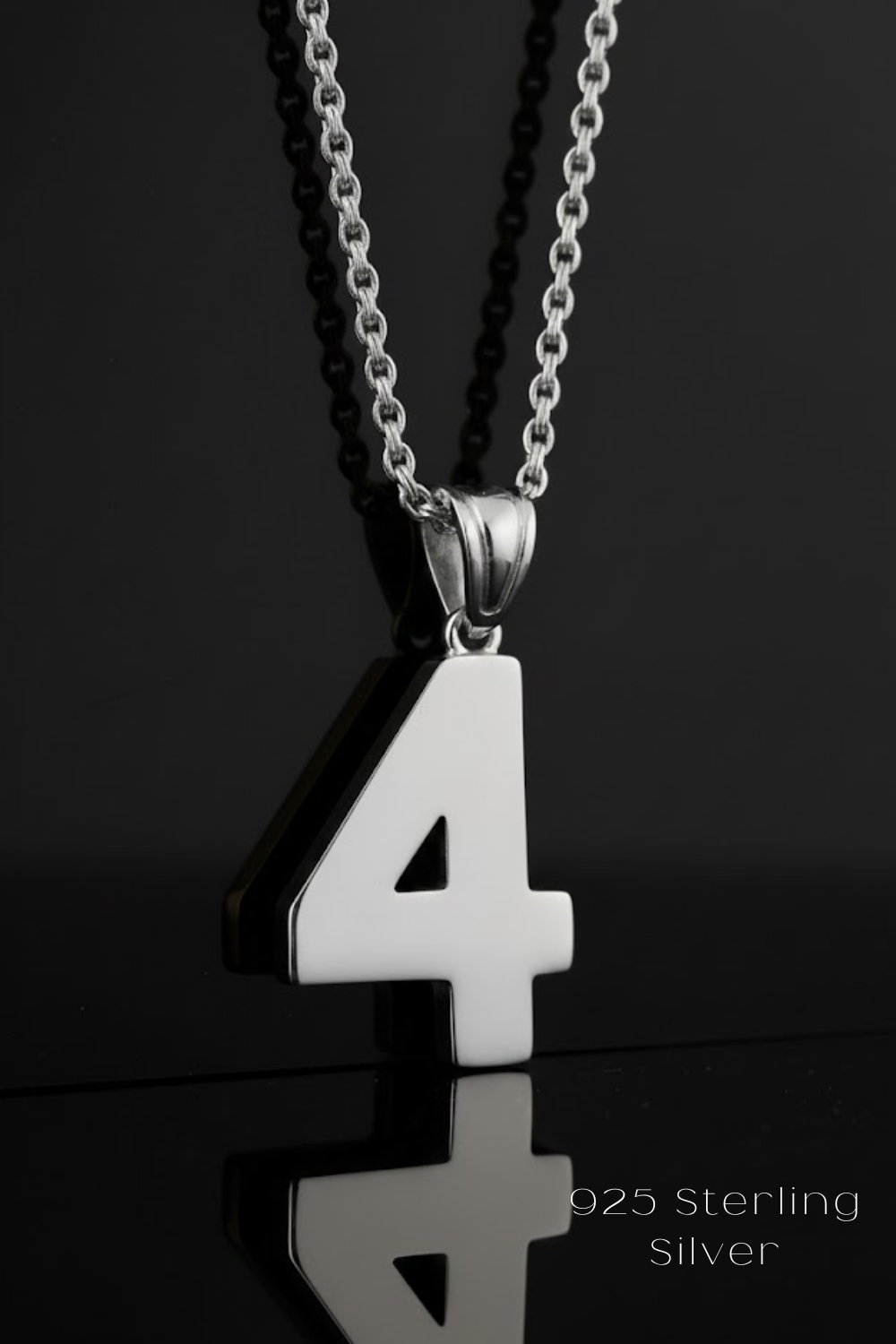 A silver-colored pendant necklace with the number 4 prominently displayed.