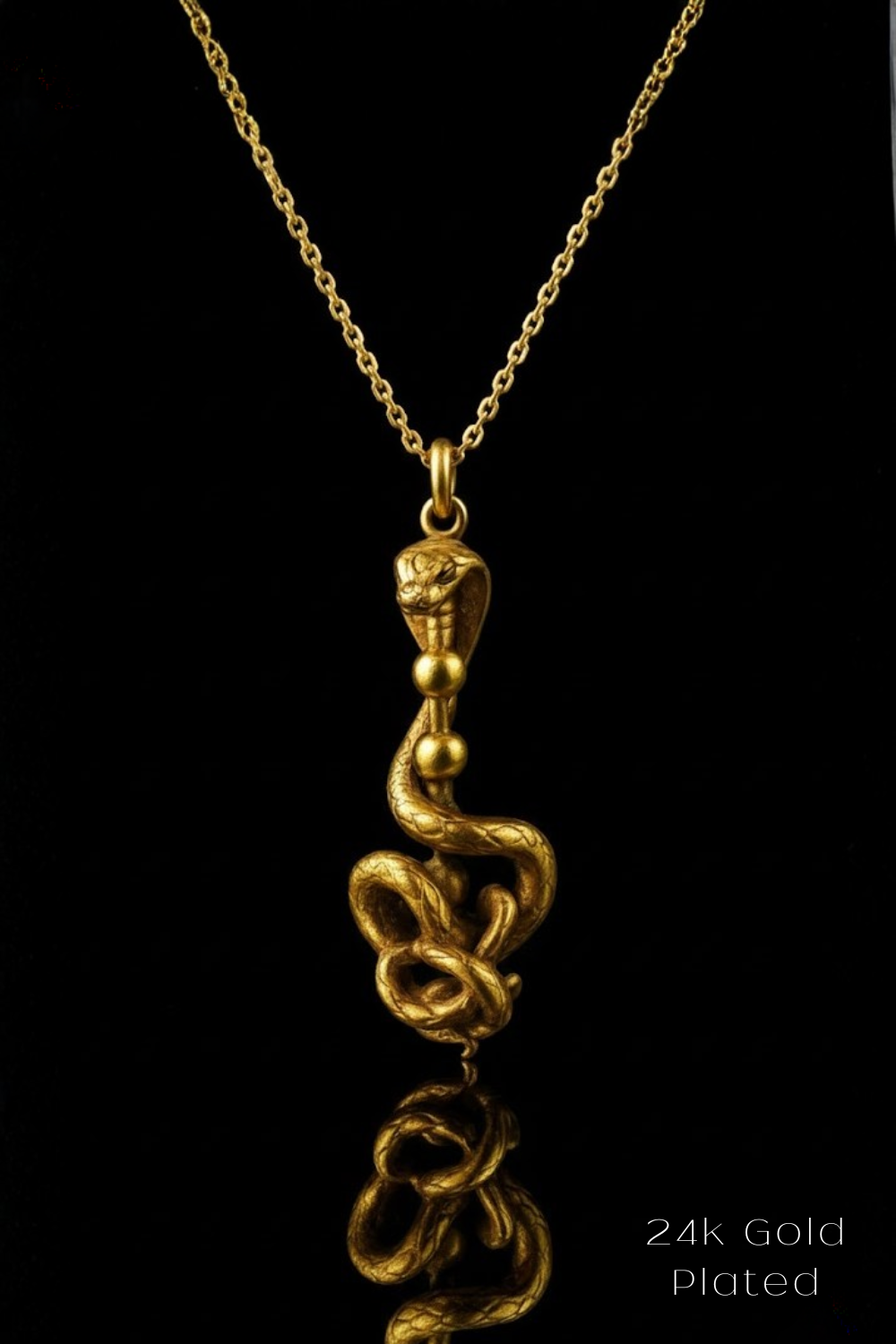 A gold-plated pendant necklace with a snake design on a chain.