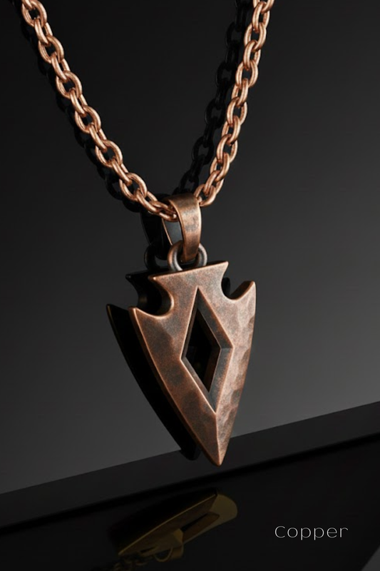 A copper-colored pendant with a diamond-shaped design, suspended from a chain against a black background.