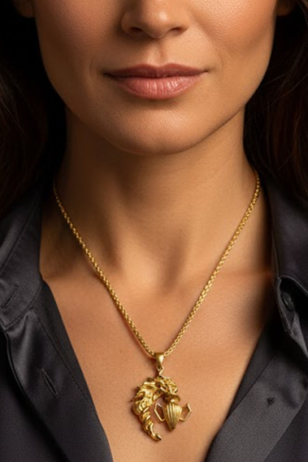 A close-up of a woman's neck and chest area, with a gold necklace featuring a pendant hanging from her neck.