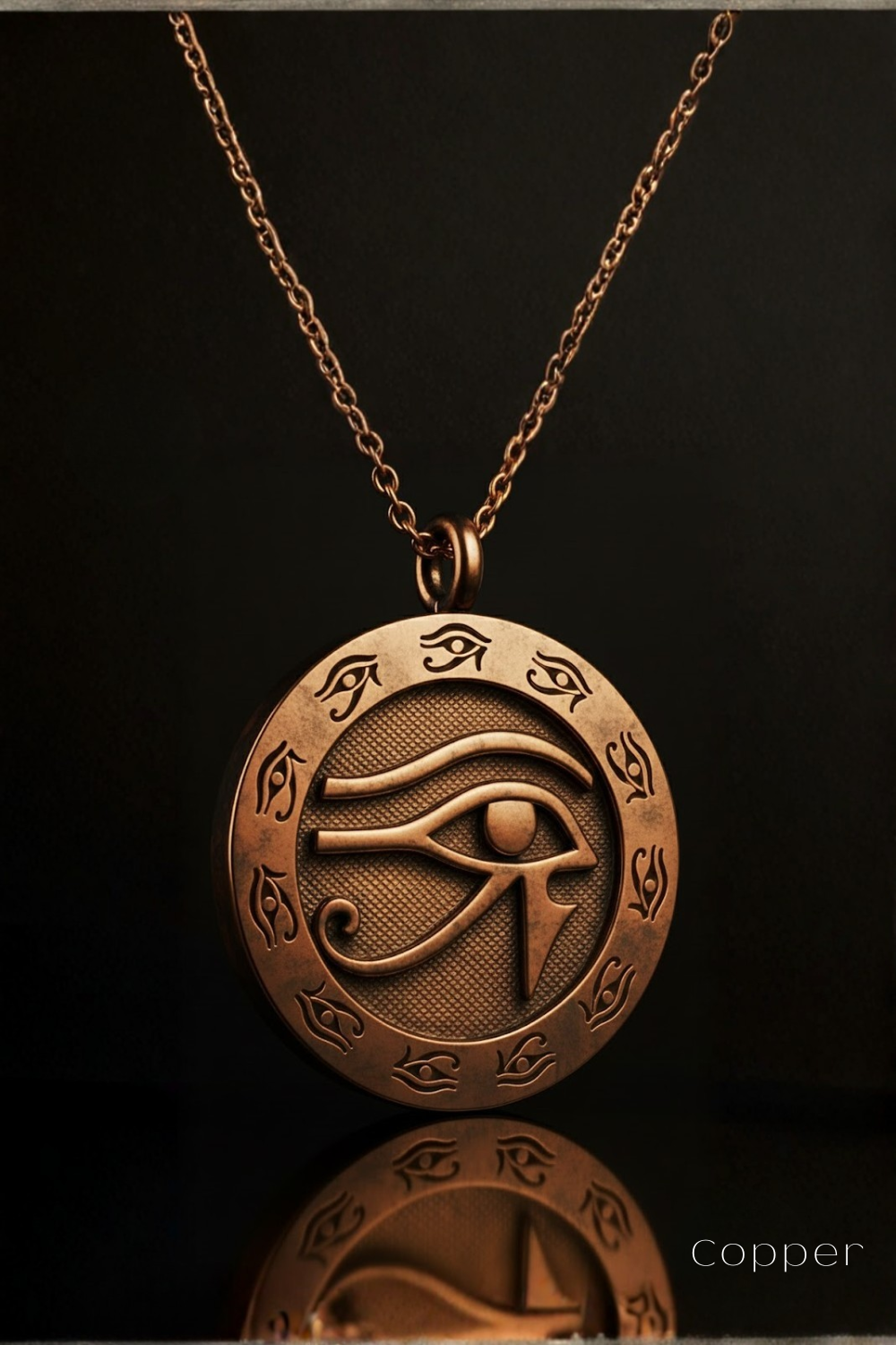 A copper-colored pendant necklace with an intricate circular design featuring an eye symbol, suspended against a dark background.