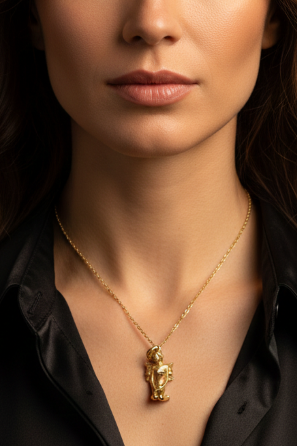 A close-up of a woman's neck and chest area, with a gold-colored pendant necklace visible.