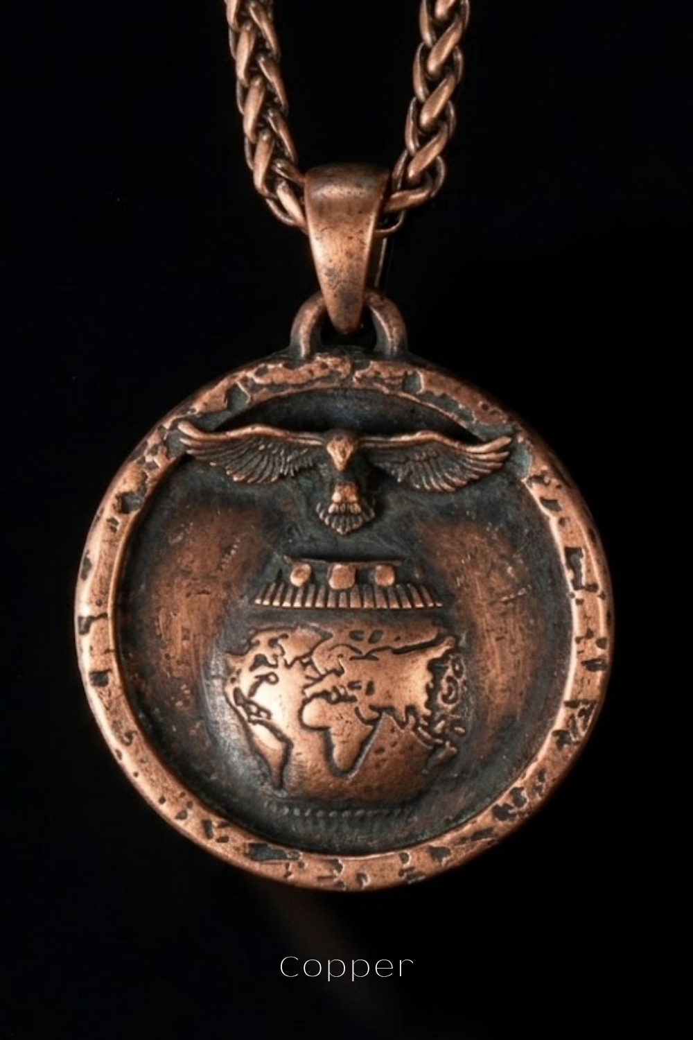 A copper-colored pendant necklace with a circular design featuring a bird, a globe, and a chain.