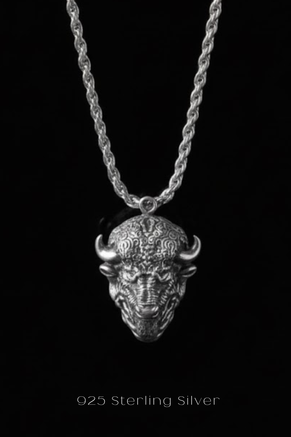 A silver pendant necklace with a detailed buffalo head design.