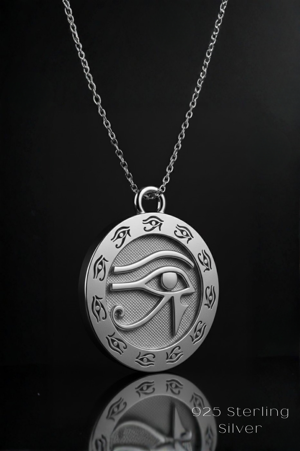 A silver pendant necklace with a circular medallion featuring the Eye of Horus, a significant symbol in ancient Egyptian mythology.