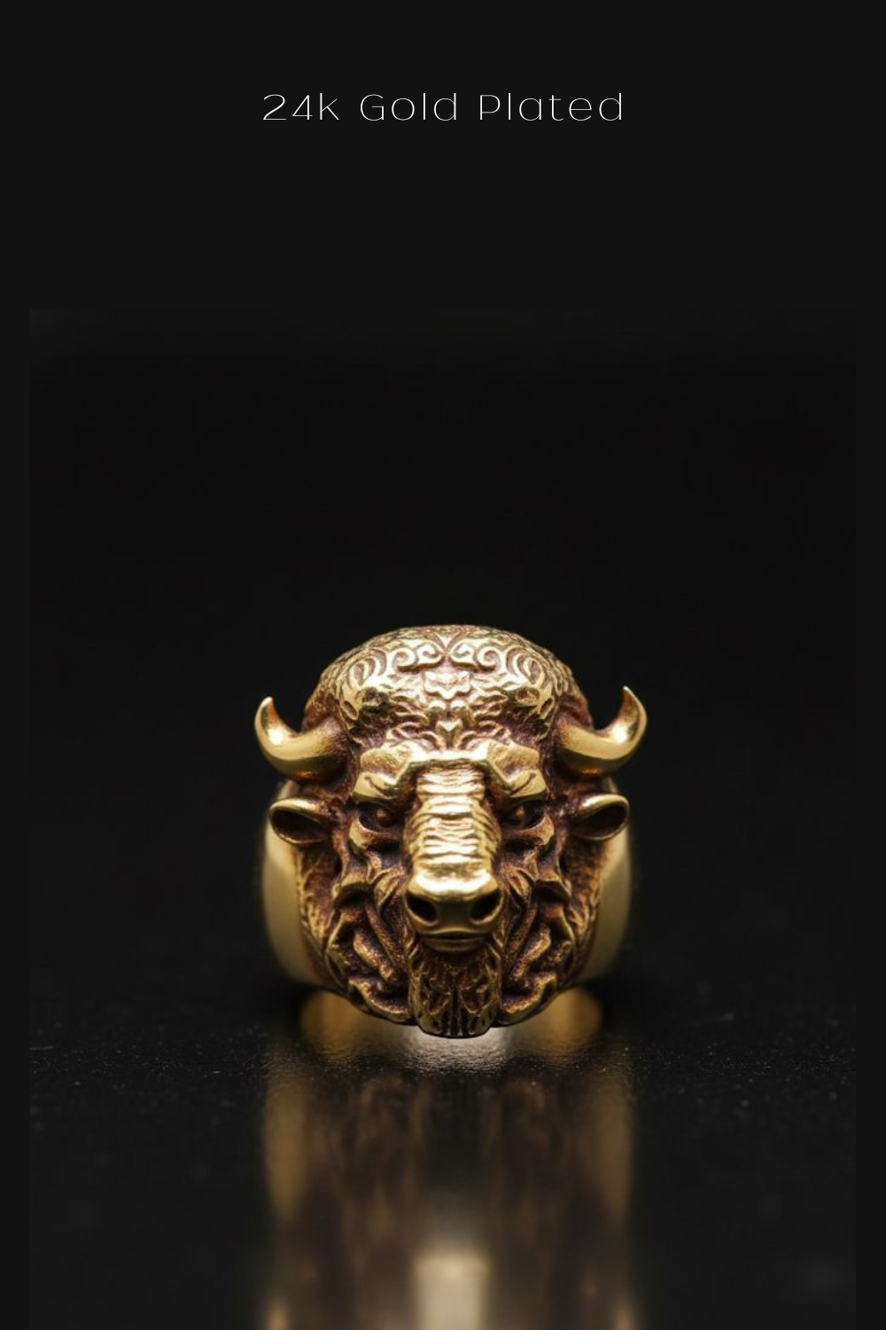 A close-up image of a gold-plated ring featuring a detailed buffalo head design.