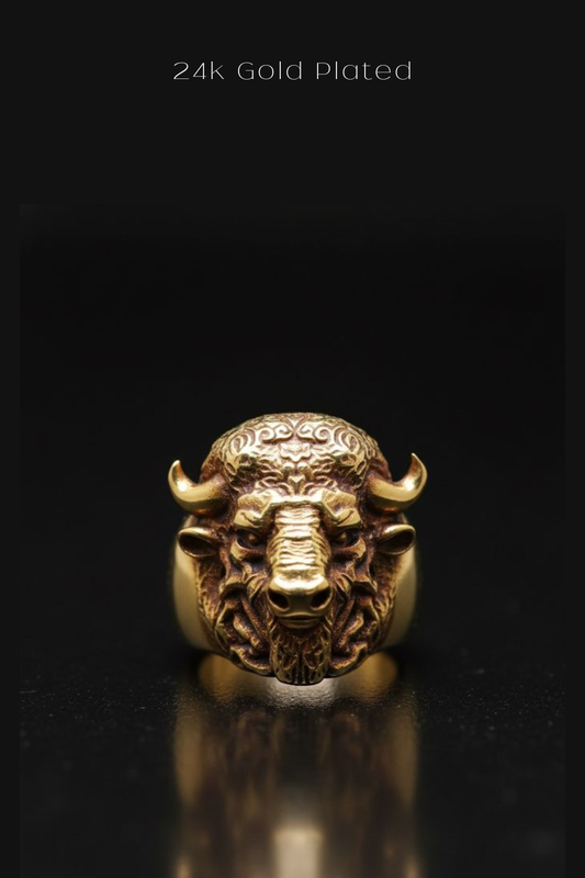 A close-up image of a gold-plated ring featuring a detailed buffalo head design.