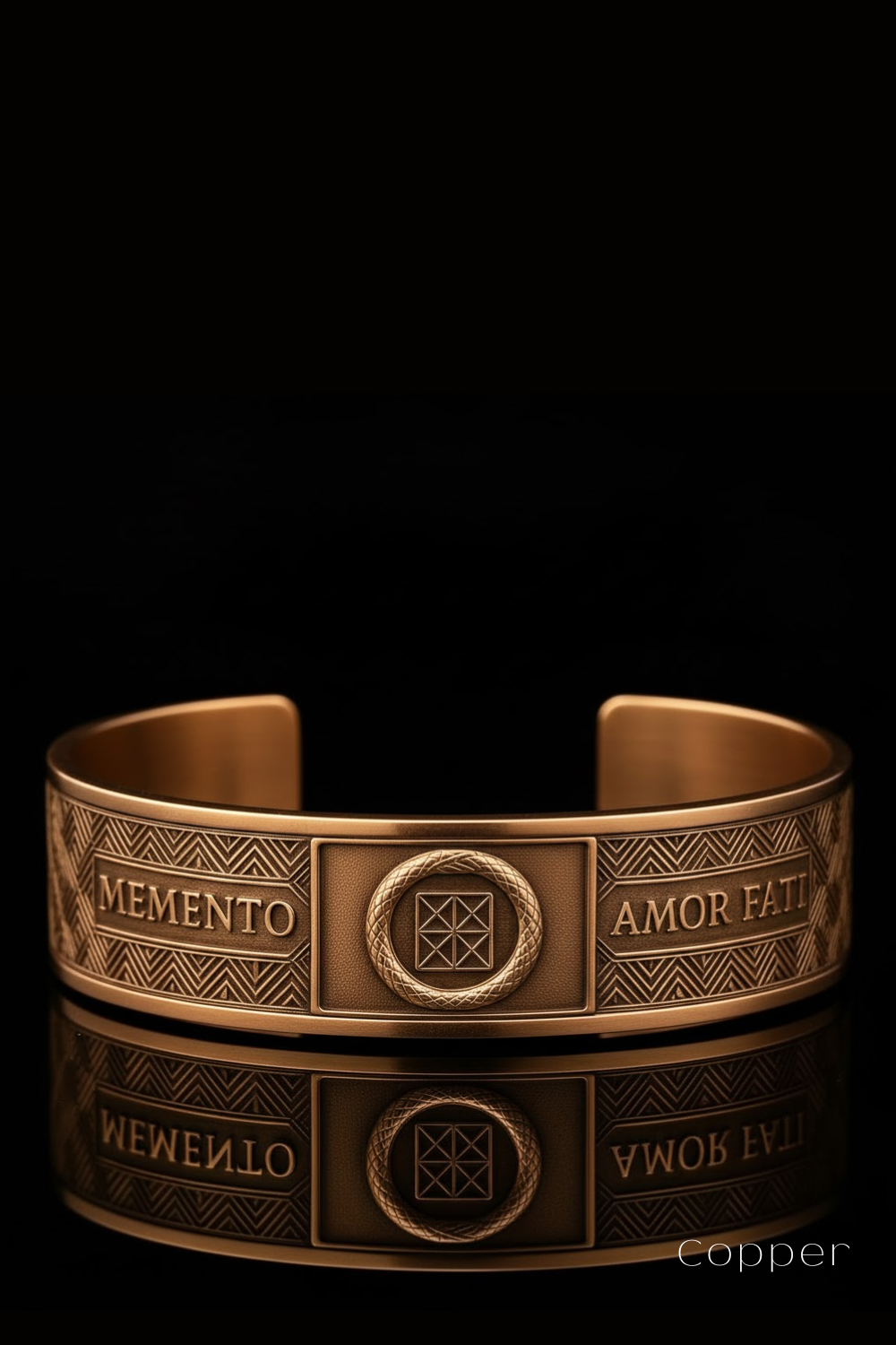 a gold-colored bracelet with a geometric pattern and the words "MEMENTO" and "AMOR FATT" engraved on it.