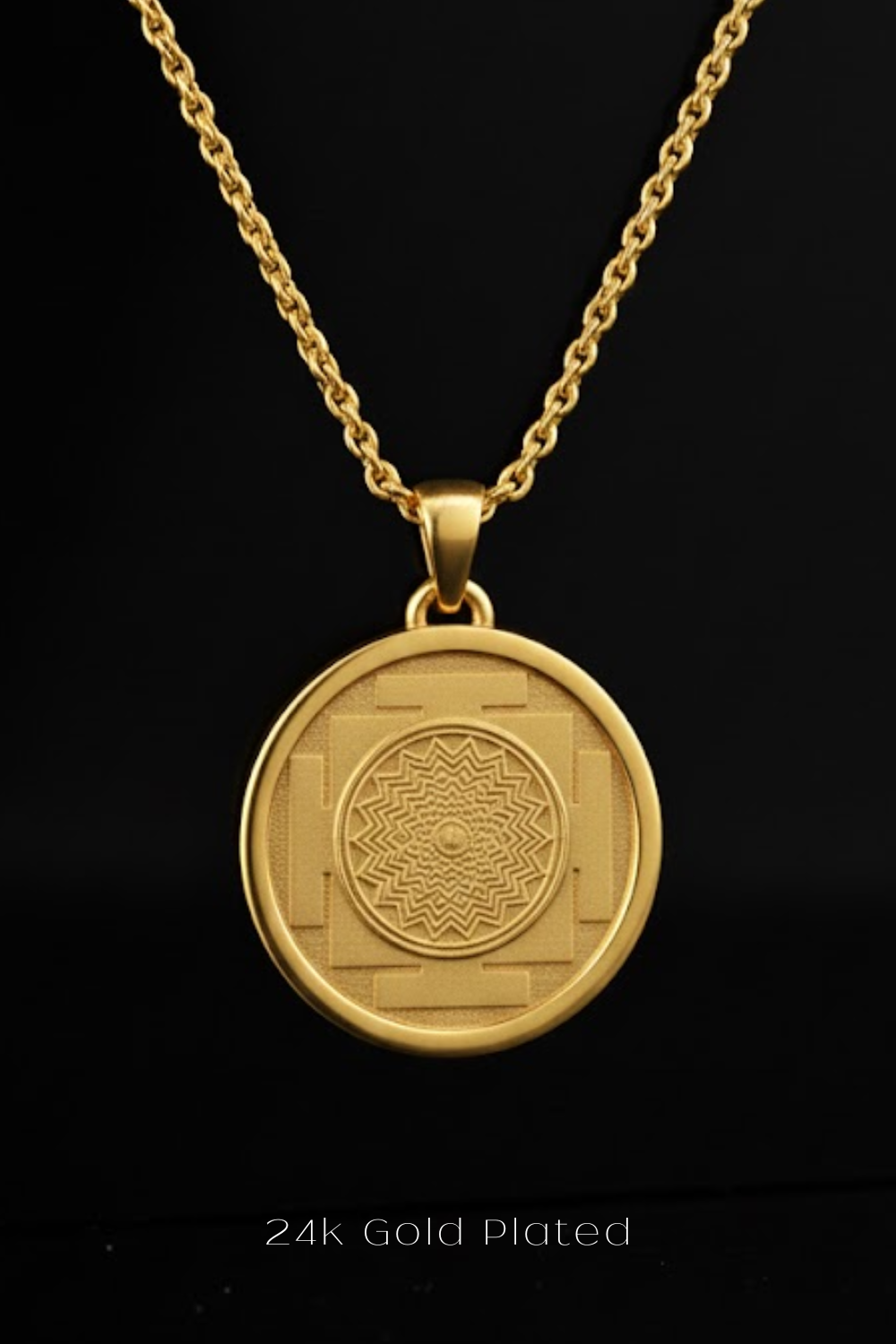 A gold-plated pendant necklace with a circular medallion featuring a geometric design.