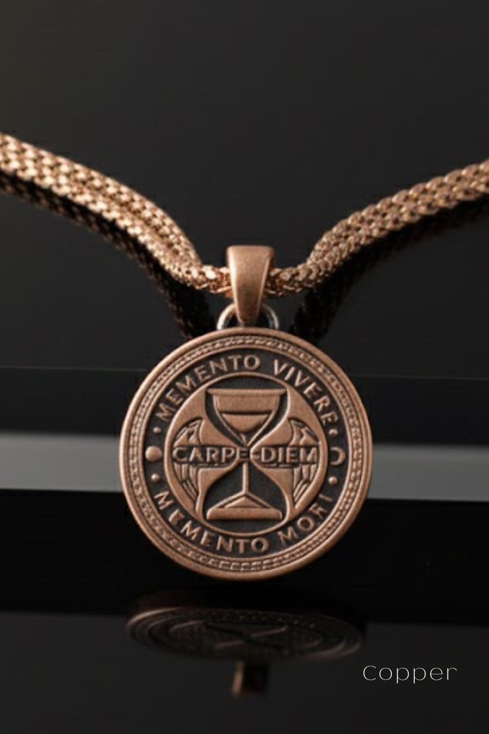 A copper-colored pendant necklace with a circular medallion featuring the Latin motto "Memento Vivere" and the words "Carpe Diem" and "Memento Mori".