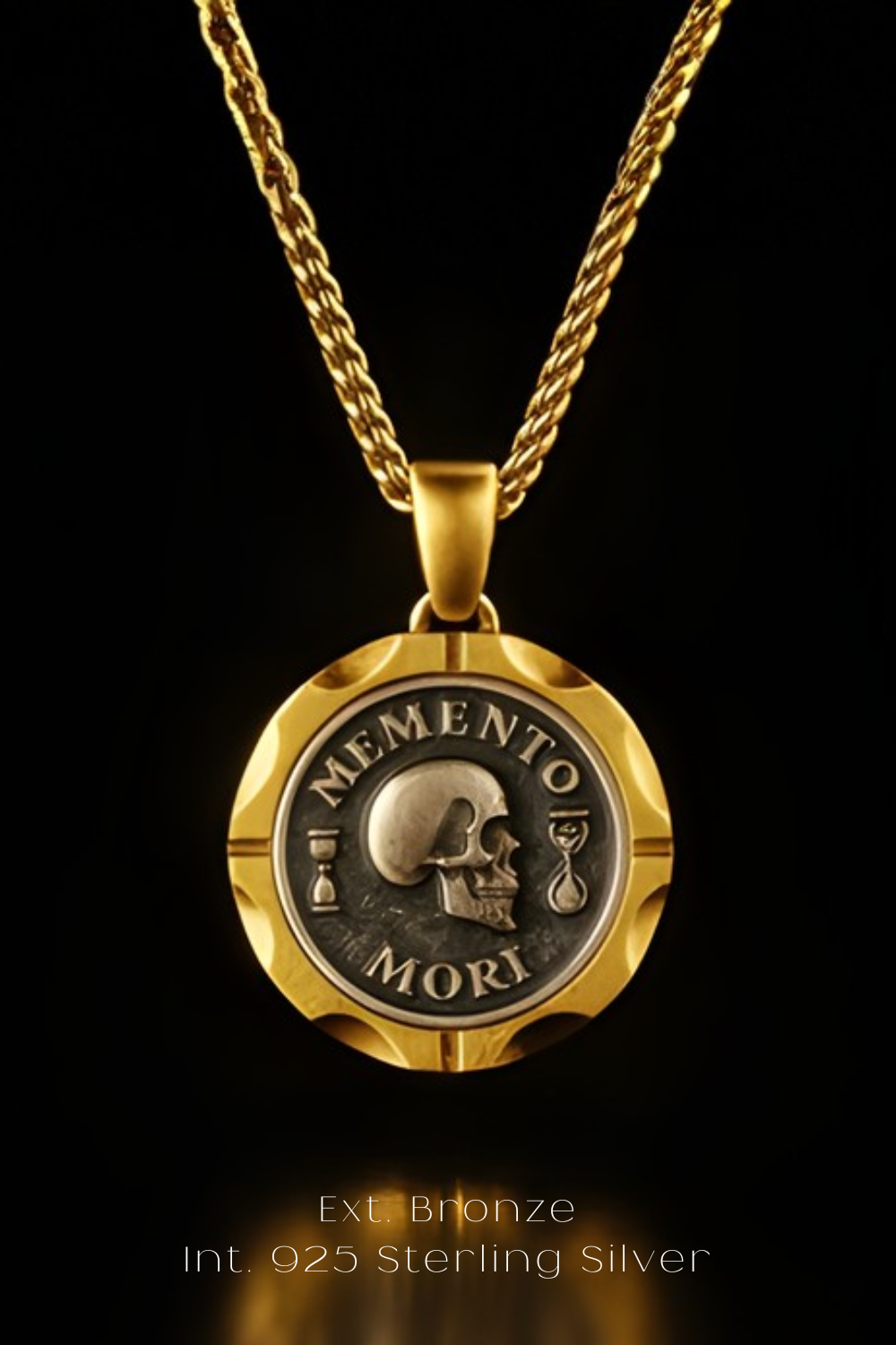 A gold-colored pendant necklace with a circular medallion featuring a skull and the Latin phrase "MEMENTO MORI" (Memento mori).