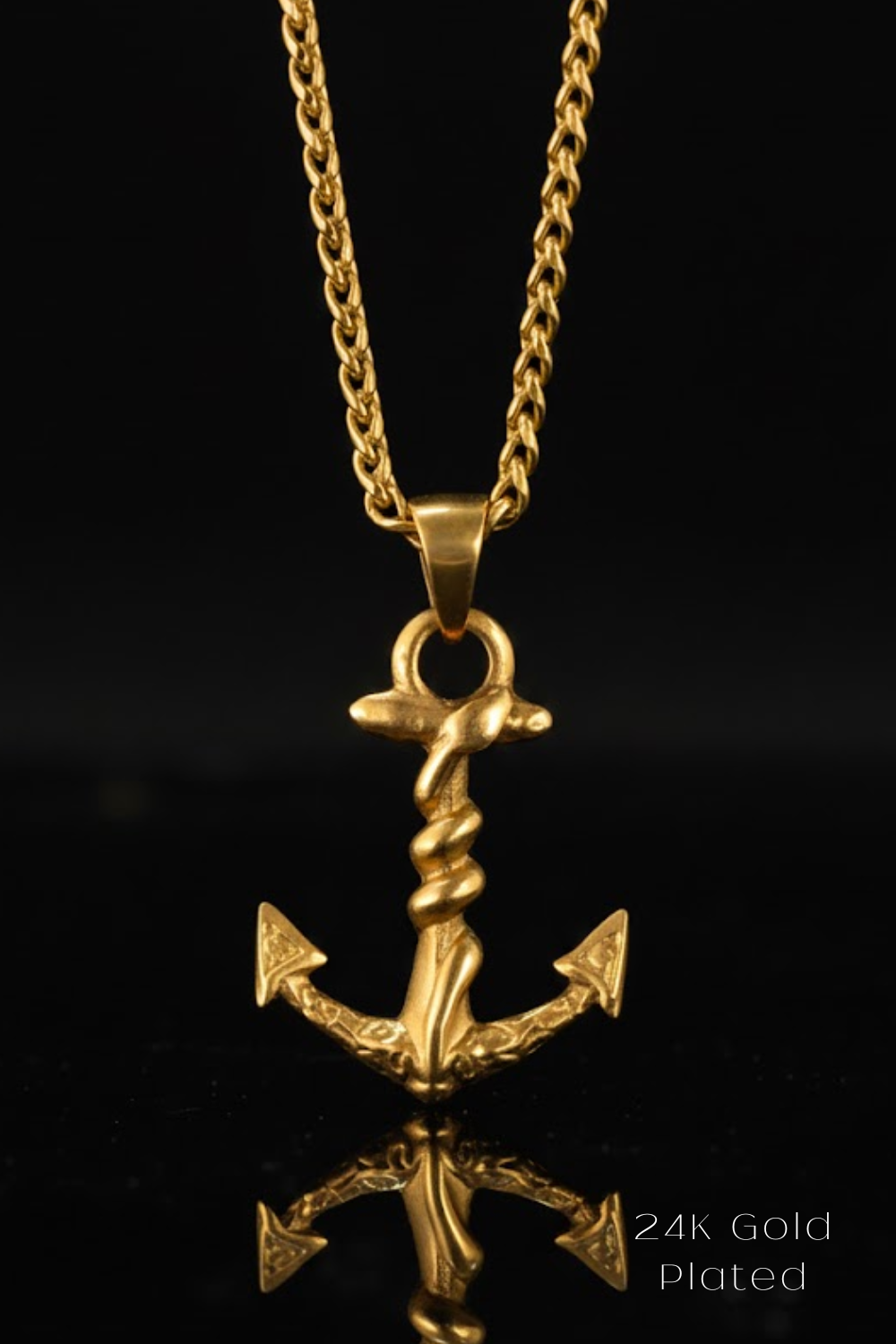 A 24K gold plated pendant featuring an intricate design of a twisted anchor on a chain against a black background.