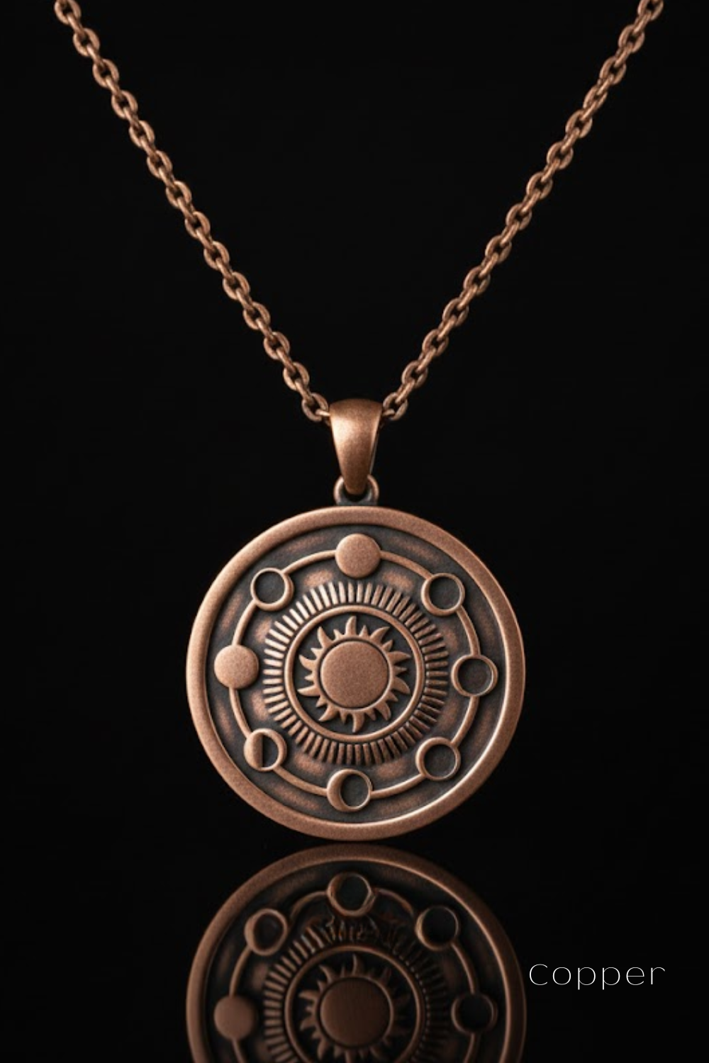 A copper-colored pendant necklace with a circular design featuring a sun-like motif and celestial elements.