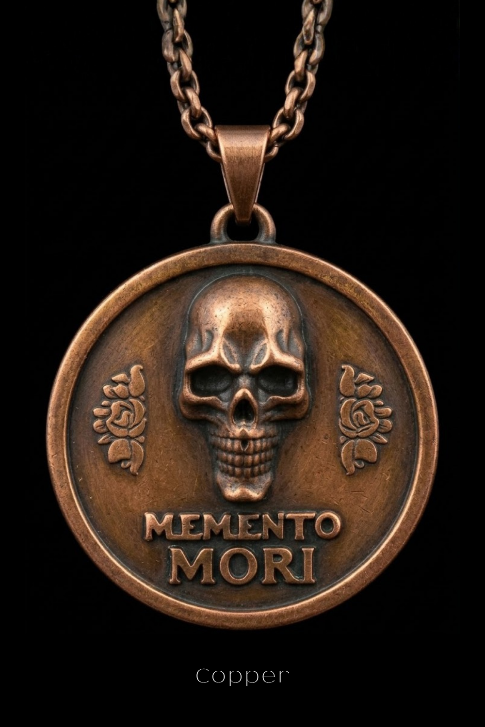 A copper-colored pendant necklace with a circular medallion featuring a skull design and the Latin phrase "Memento mori" (which means "Remembering the dead" in English).