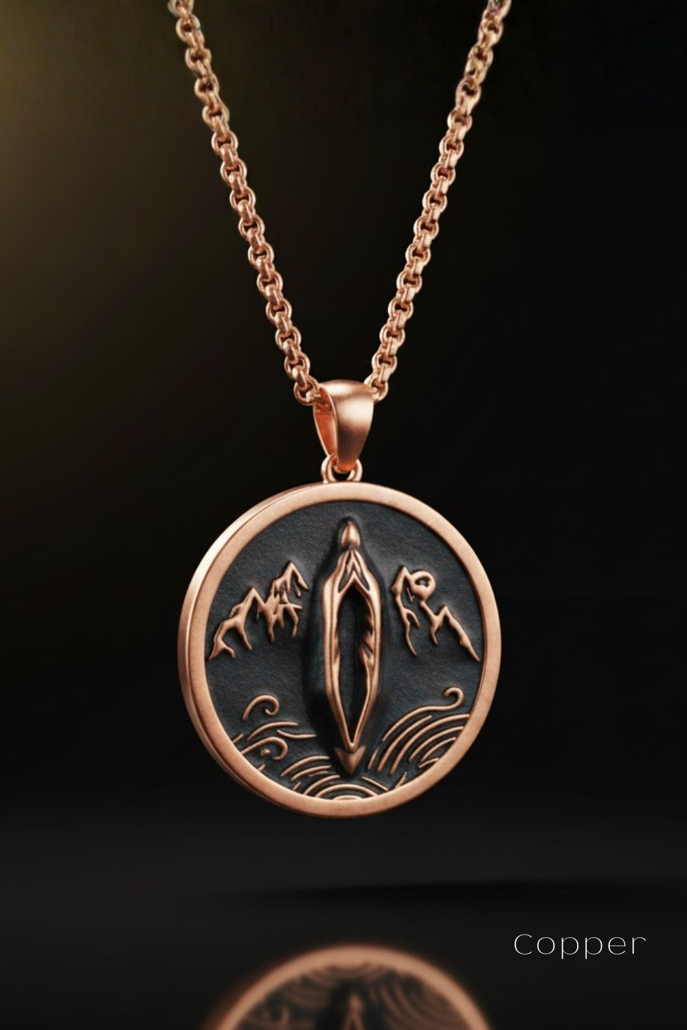 A copper-colored pendant necklace with a circular design featuring a stylized figure and mountains.