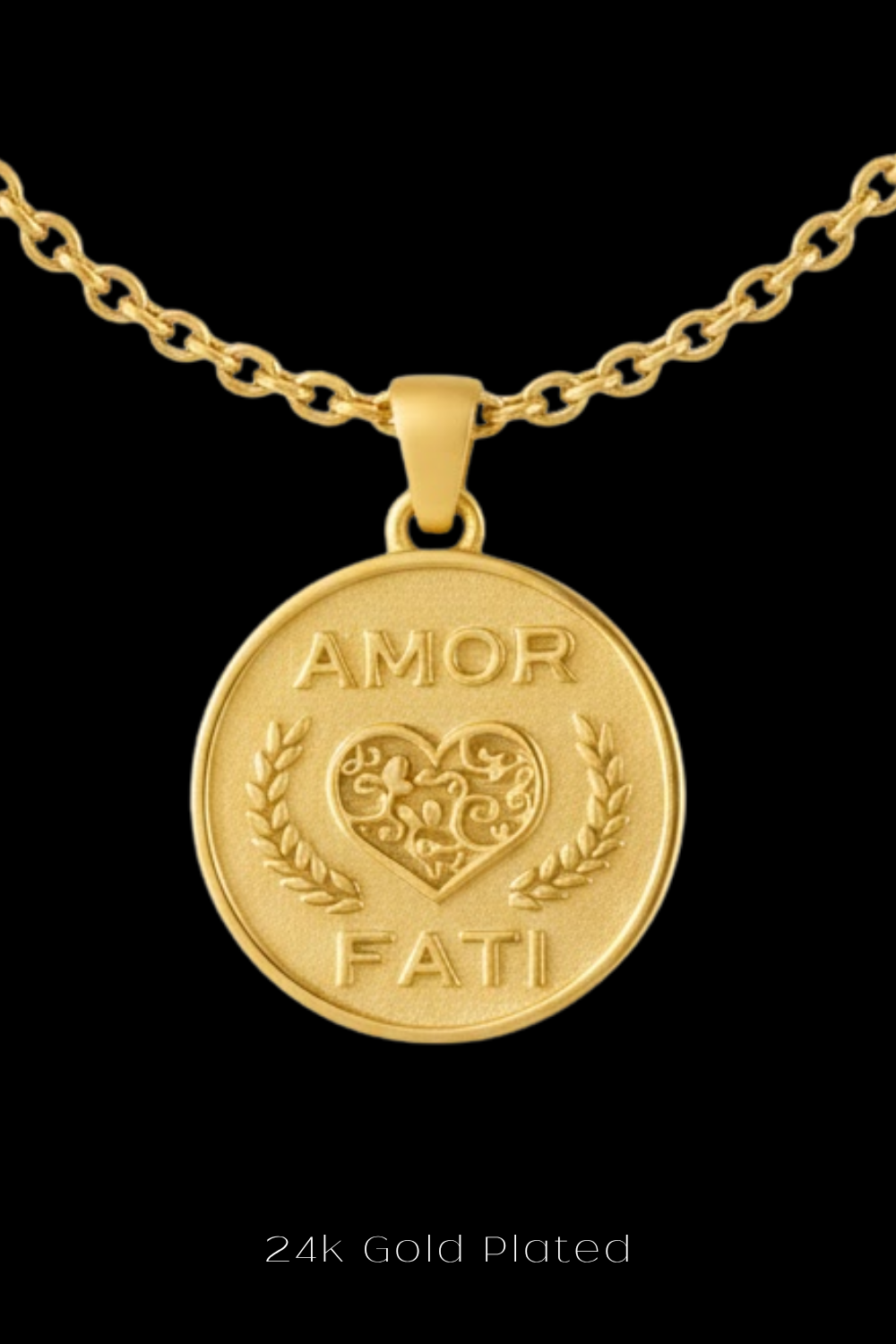 A 24k gold-plated pendant necklace with a circular medallion featuring the words "Amor Fati" and a heart-shaped design.