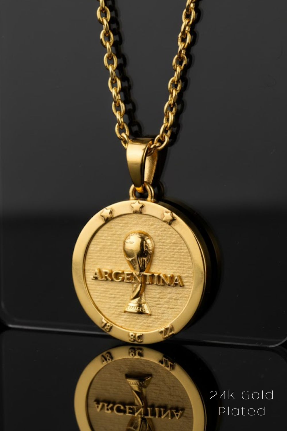A 24k gold-plated pendant necklace with a circular medallion featuring the word "ARGENTINA" and a soccer ball design.