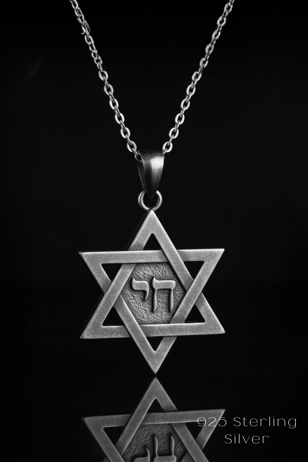 A silver-colored pendant necklace with a Star of David pendant, which is a symbol associated with Judaism and the Jewish faith.