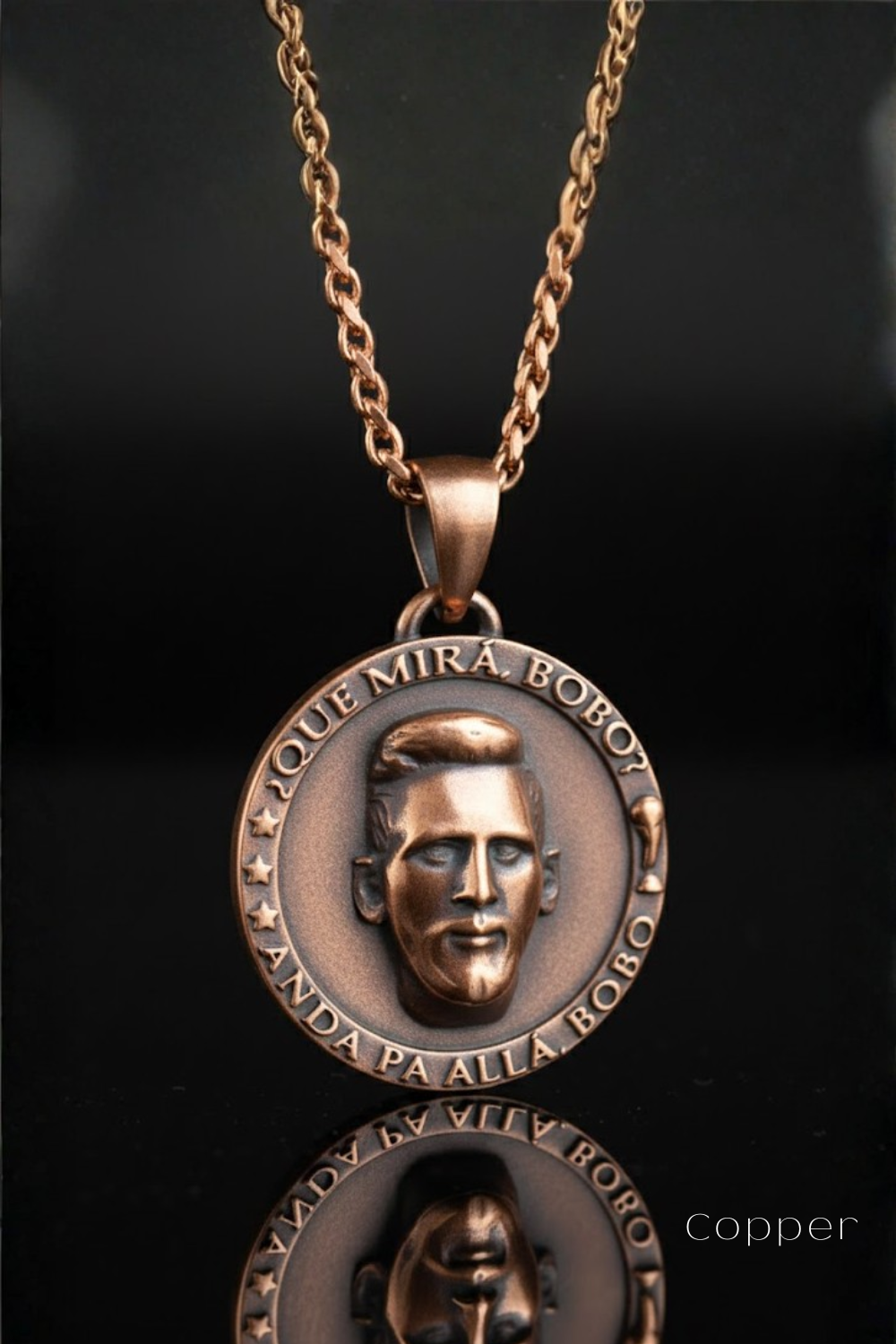 A copper-colored pendant necklace with a circular medallion featuring a portrait of a man's face.