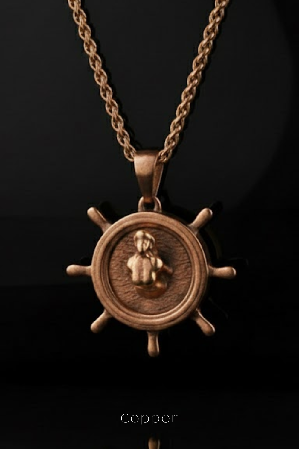 A copper-colored pendant necklace with a circular medallion featuring a figure of a woman.