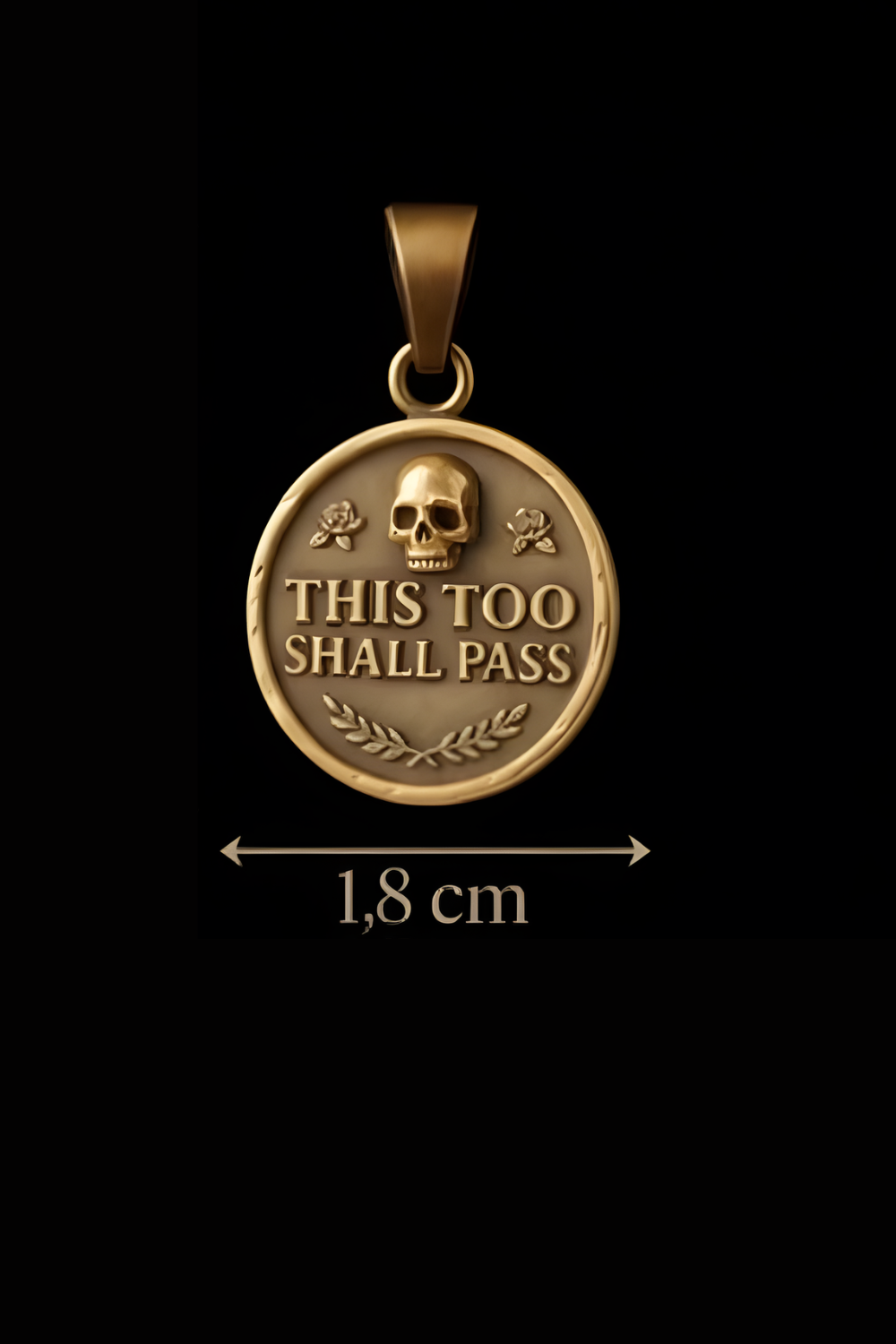 A gold-colored pendant with a skull and laurel wreath design, and the text "THIS TOO SHALL PASS" on it.