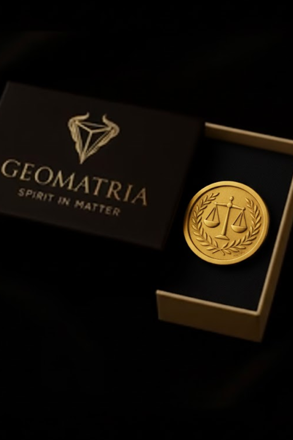 a gold coin with a laurel wreath and scales, placed inside a black box with the word "Geomatria" printed on it.